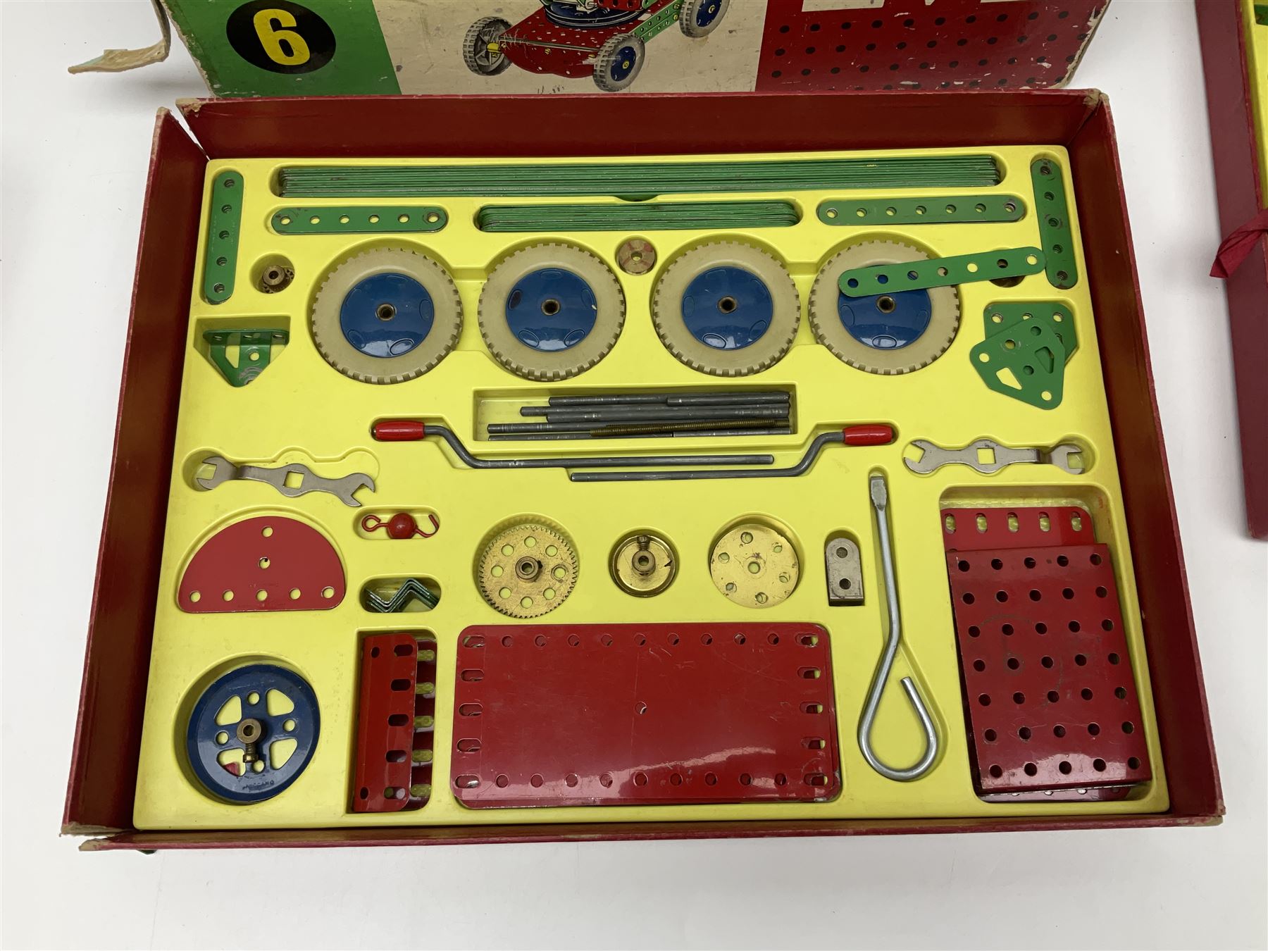 Meccano - Outfits 4, 6 & 7 with red and green parts; Outfits 4 & 6 virtually fully stocked and Outfit 7 containing large quantity of loose parts; Outfits 4 & 7 with instruction manuals; all boxed (3)