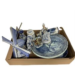 Collection of Delft ware, to include Two chargers, the first example depicting a river scene, the second depicting a horse and carriage, two windmill lamps, decorative plates, etc