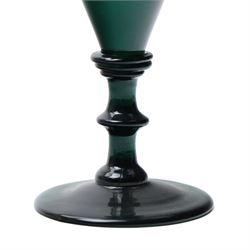 Five green wine glasses of early 19th century design with conical bowls and double knop stems on a circular foot, with pontil marks, pair of green wine glasses with chamfered stems together with an Asprey catalogue of green glass 1740-1840 and two pieces of glass fruit and leaves