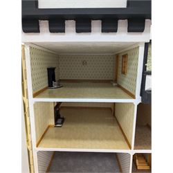 1:24 scale four-storey tudor-style dolls house, with black and white exterior, balcony garden, glazed panelled windows and wooden shingle roof, with decorated interior and wired fireplaces and lighting, H65cm, W58cm, D31cm, 