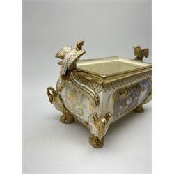 19th century Coalport bough pot, circa 1820, of bombe form, the body with twin handles surmounted by two birds and raised upon four feet modelled as swans, hand painted with two panels depicting an urn of flowers set against a mountainous landscape, the whole heightened in gilt throughout, H13cm L21cm