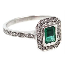  White gold emerald cut emerald and round diamond cluster ring, with diamond set shoulders, hallmarked 18ct   