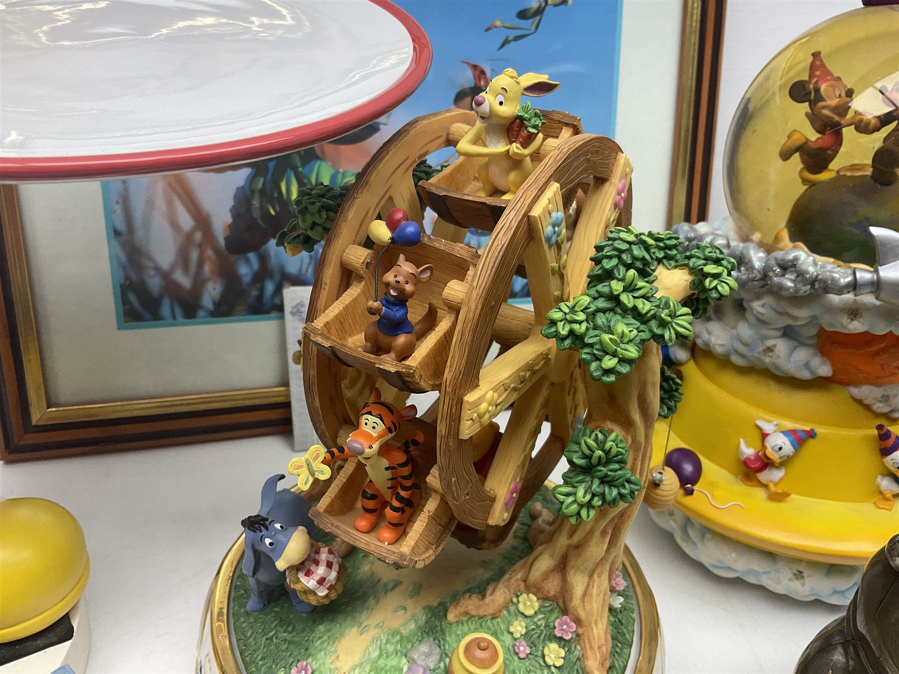 Collection of Disney figures, to include Ardleigh Elliott music box Hunny of the Day, Disney musical snow globe, Micky mouse lazy butler, Framed Bug's Life lithograph etc 