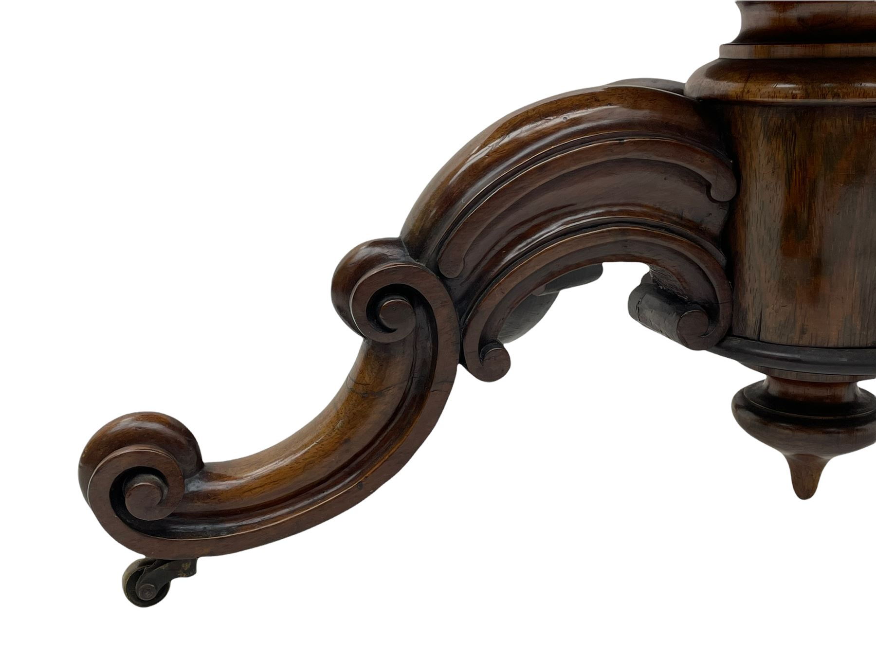 Victorian figured rosewood card table, fold-over swivel top with circular baize lining, moulded frieze with stylised flower head carving to corners, turned column with egg and dart decoration, on quadruple splayed c-scroll carved supports, with brass castors