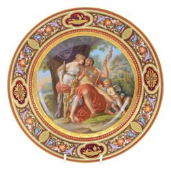 Royal Vienna plate, featuring Hercules and Omphale, the rim decorated with floral and gilt motifs, blue beehive mark beneath, D25cm