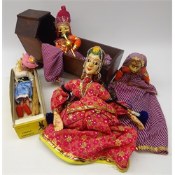  Three Indian painted wood and cloth marionette puppets, Pelham Standard puppet, boxed and a Victorian mahogany dolls cradle, L46cm   