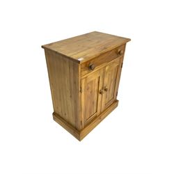 Pine cupboard, rectangular top over single drawer and two panelled doors enclosing shelf