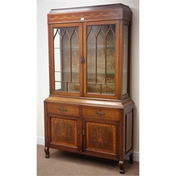  Edwardian inlaid mahogany display cabinet, inverted cornice, two glazed doors enclosing glass shelves above two drawers and two cupboard doors, scrolled supports, W111cm, H191cm, D37cm  