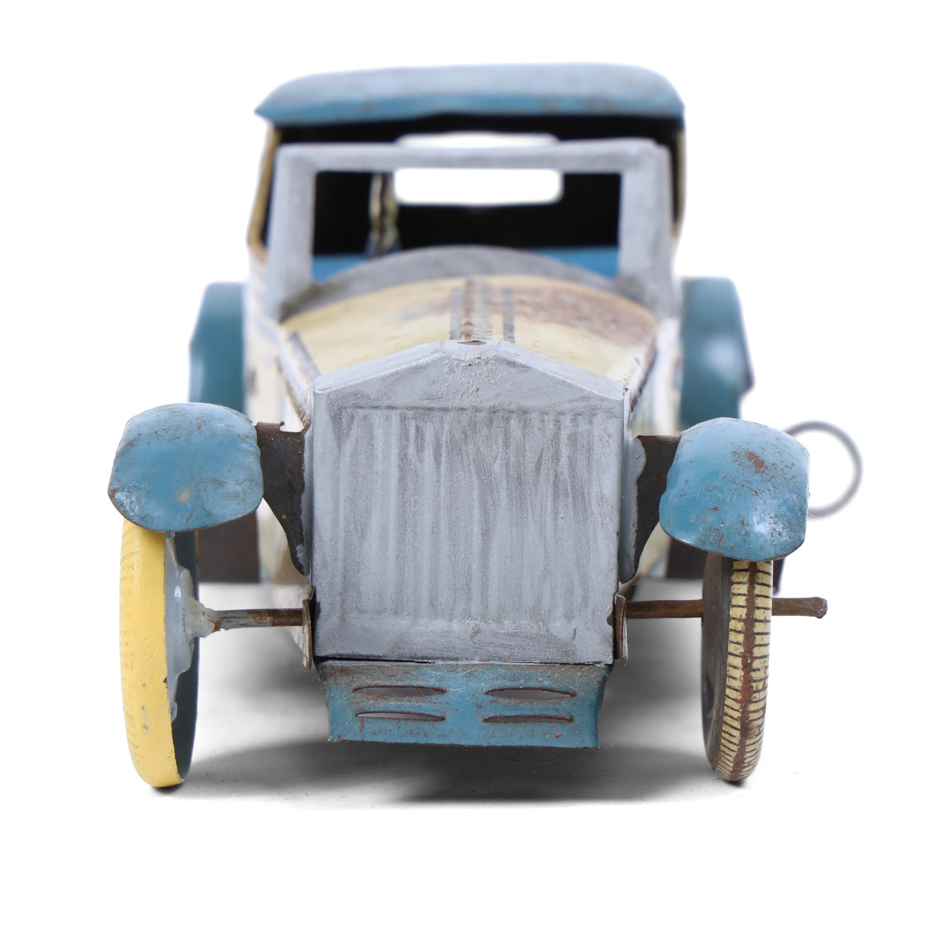 Wells tinplate clockwork limousine, the cream body, with blue roof and lithographed details, with driver and key, H8cm, L23cm