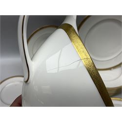 Royal Doulton Royal Gold pattern tea and dinner service for eight, comprising dinner plates, side plates, tea plates, soup bowls, sauce boat and saucer, dessert bowls, coffee cans and saucers, teacups and saucers and two lidded tureens