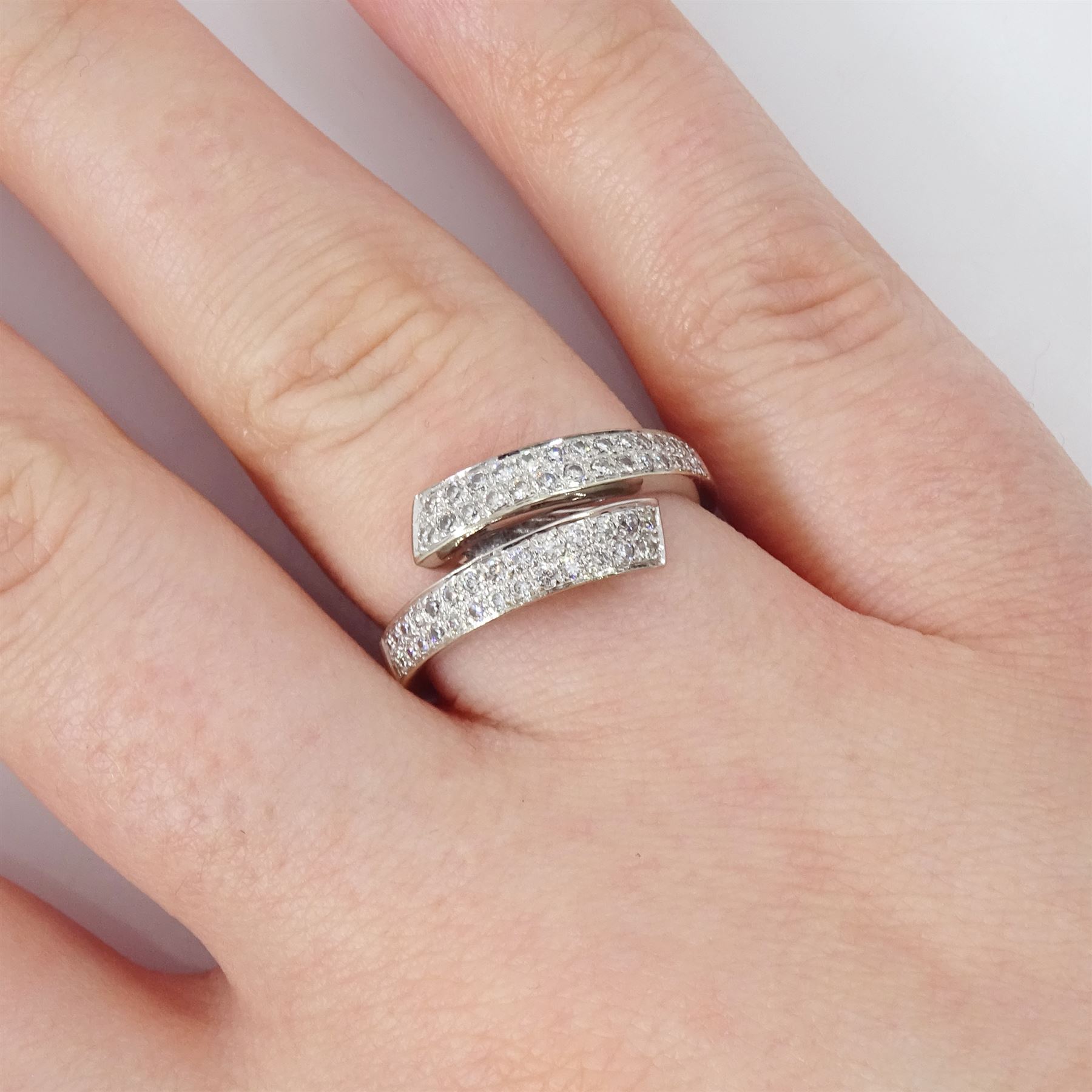 18t white gold diamond crossover ring, two rows of pave set round brilliant cut diamonds, hallmarked, total diamond weight 0.34 carat