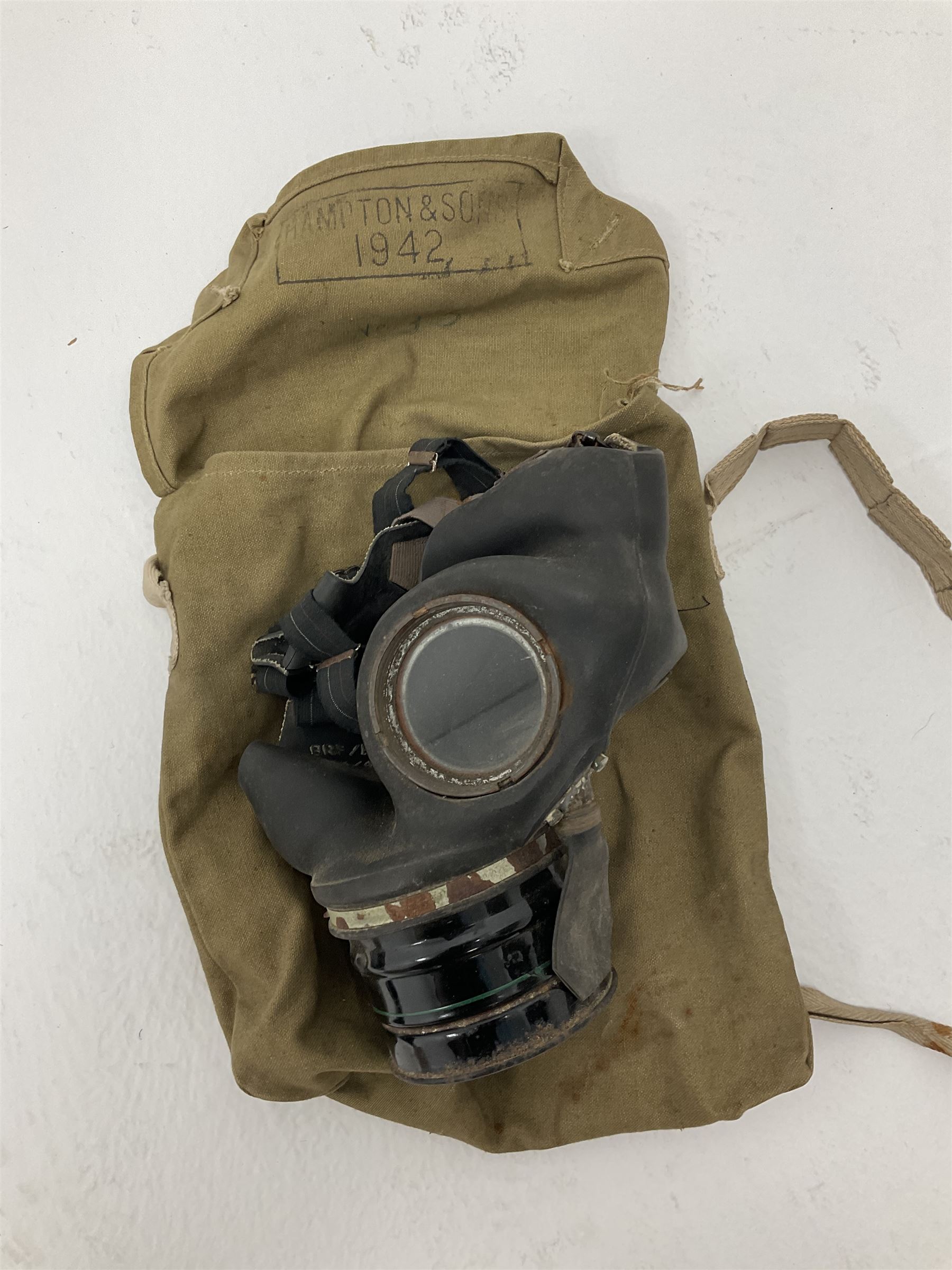 RAF Flight Lieutenant's uniform with peaked cap and WW2 ribbon bar; WW2 gas mask in blue canvas bag dated 1942; flying helmet date 1984; and British Army Major's uniform with Staybrite buttons and peaked cap
