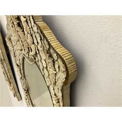 Pair 19th century French Dieppe bone and ivory wall mirrors, the oval bevelled mirror plates within rectangular frames with shaped tops, profusely decorated with ivory leaves, further detailed with carved bone armorial type crest inscribed 'SGOTORVM', putti, fish and mask heads, H81cm W48cm