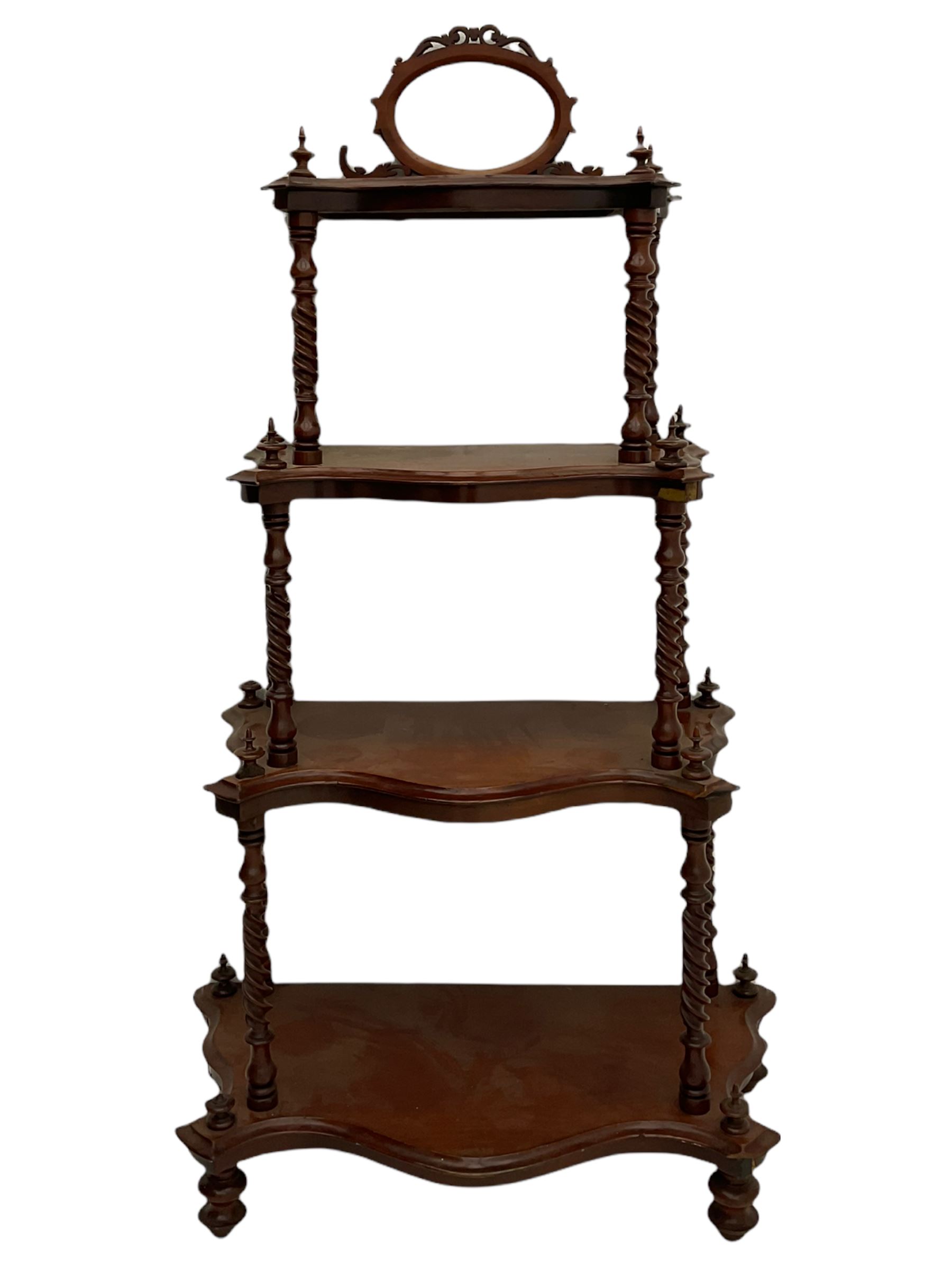 Victorian mahogany etagere, raised oval mirror in fretwork frame, four graduating shaped tiers, spiral turned supports