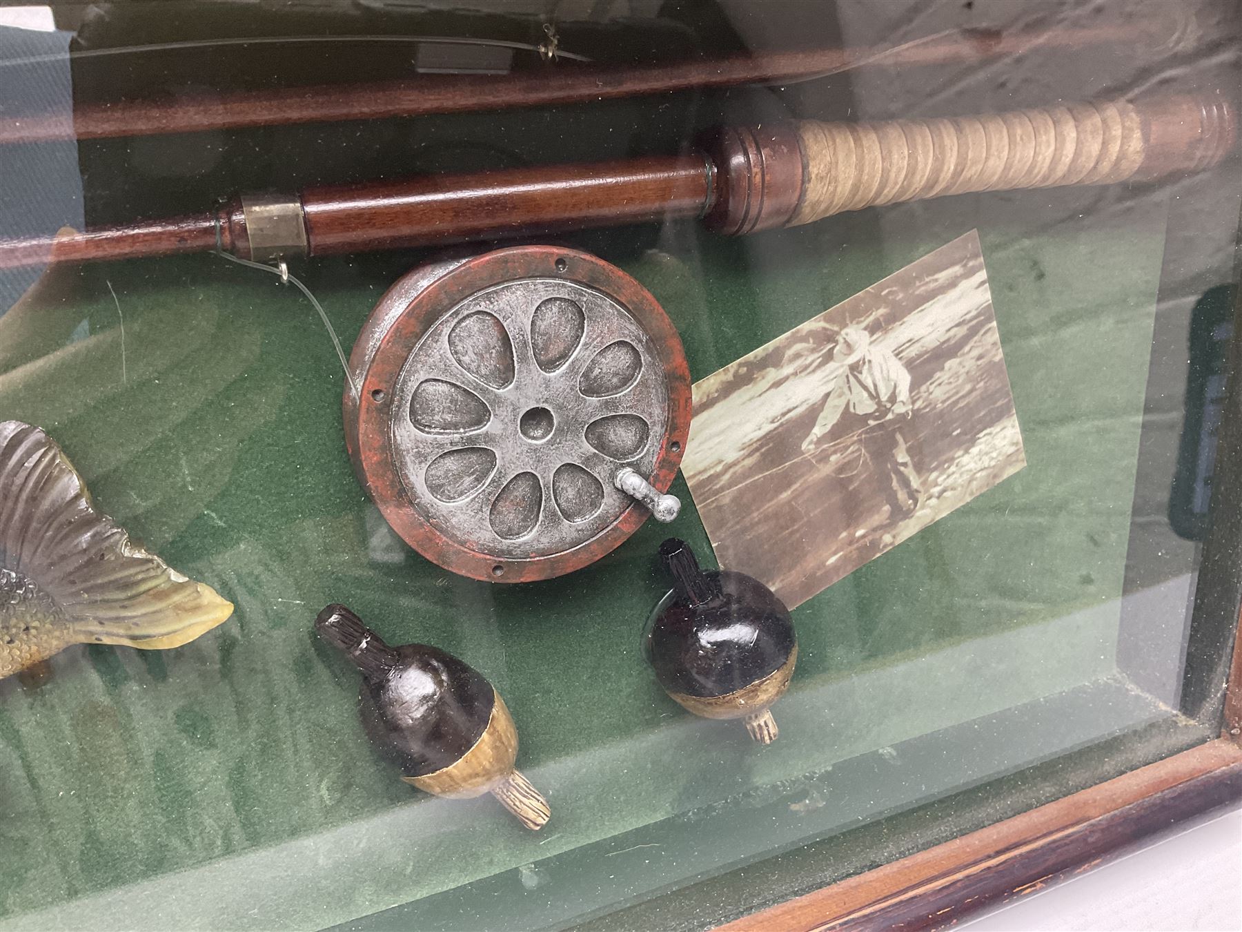 Four framed sporting memorabilia displays, the largest example containing 1930s cricket memorabilia, together with two fishing displays and a football display, each within wooden glazed frames, largest H105cm