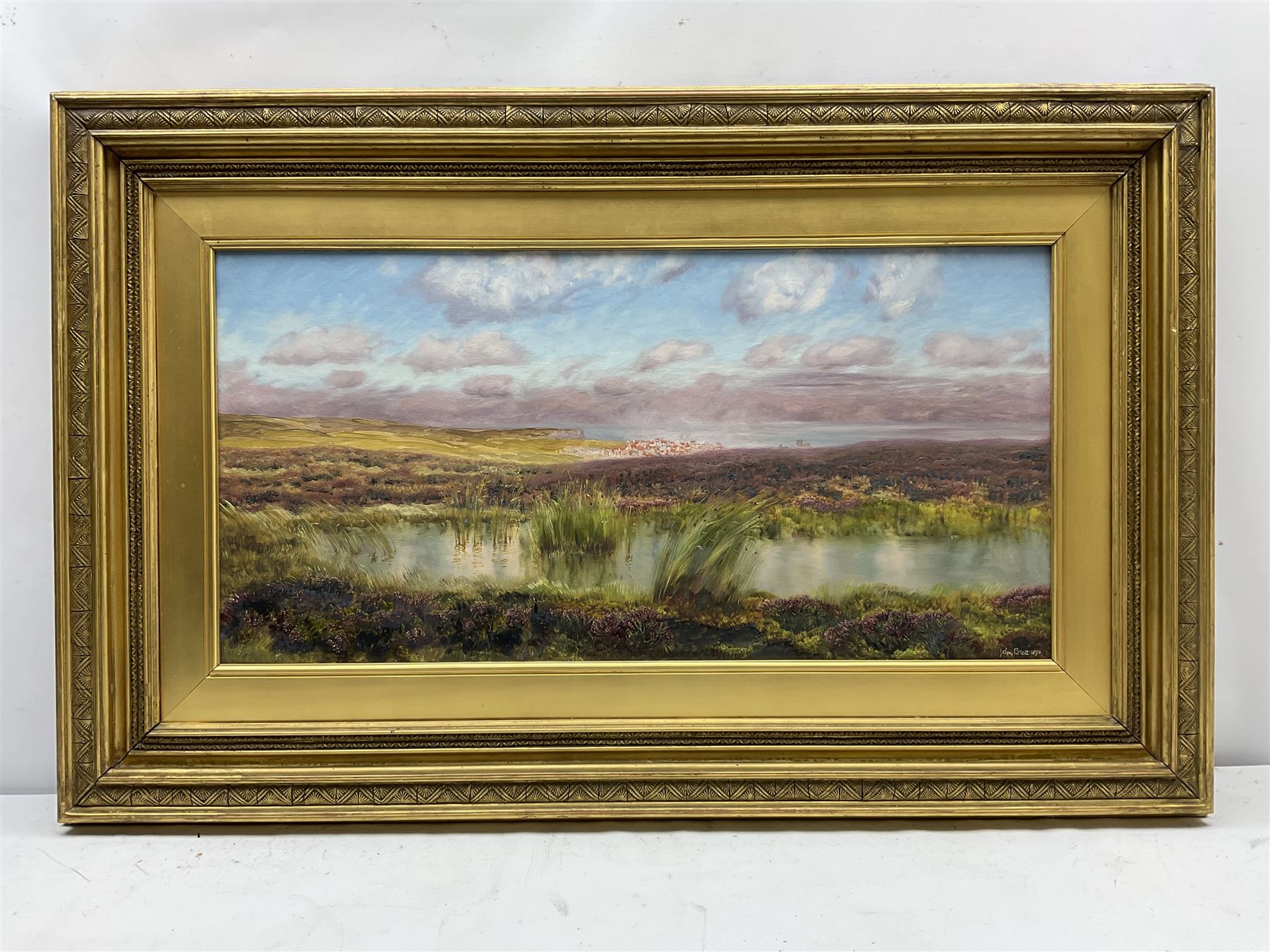 John Brett (British 1831-1902): 'Fylingdales Moor' looking towards Whitby, oil on canvas signed and dated 1890, 38cm x 76cm
Provenance: East Yorkshire private collection; exh. Royal Academy 1891 No.458; purchased by W.A. Pye Esq. in February 1891 for the sum of £100, then by descent through the Pye family; Sotheby's London 12th November 1992, Lot 132; Thomas Agnew & Sons Ltd. London (then listed as Treyarnon Bay) No.WA2457 (label verso) where purchased by J.E. Dayton; Sotheby's London 10th March 2005, Lot 217, where purchased by the vendor (at the same sale an oil sketch of the same scene was sold as Lot 218).
Literature: Birmingham Daily Post 30th May 1891; C. Payne & C. Brett: John Brett: Pre-Raphaelite Landscape Painter (Yale Univ. Press 2010) Cat no.1350, ill p 236
Notes: The painting has previously been erroneously listed as Treyarnon Bay; this is because the frame, made for the artist by Dolman & Son, previously contained 'Treyarnon Bay' of 1889, and a label previously affixed to the frame displayed this title.