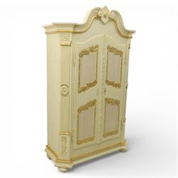 20th century French white and parcel gilt painted armoire, the shaped and scroll moulded c...