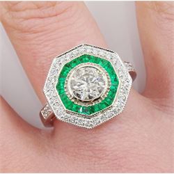 White gold round brilliant cut diamond and calibre cut emerald hexagonal ring, stamped 14K, central diamond 1.02 carat, with World Gemological Institute report