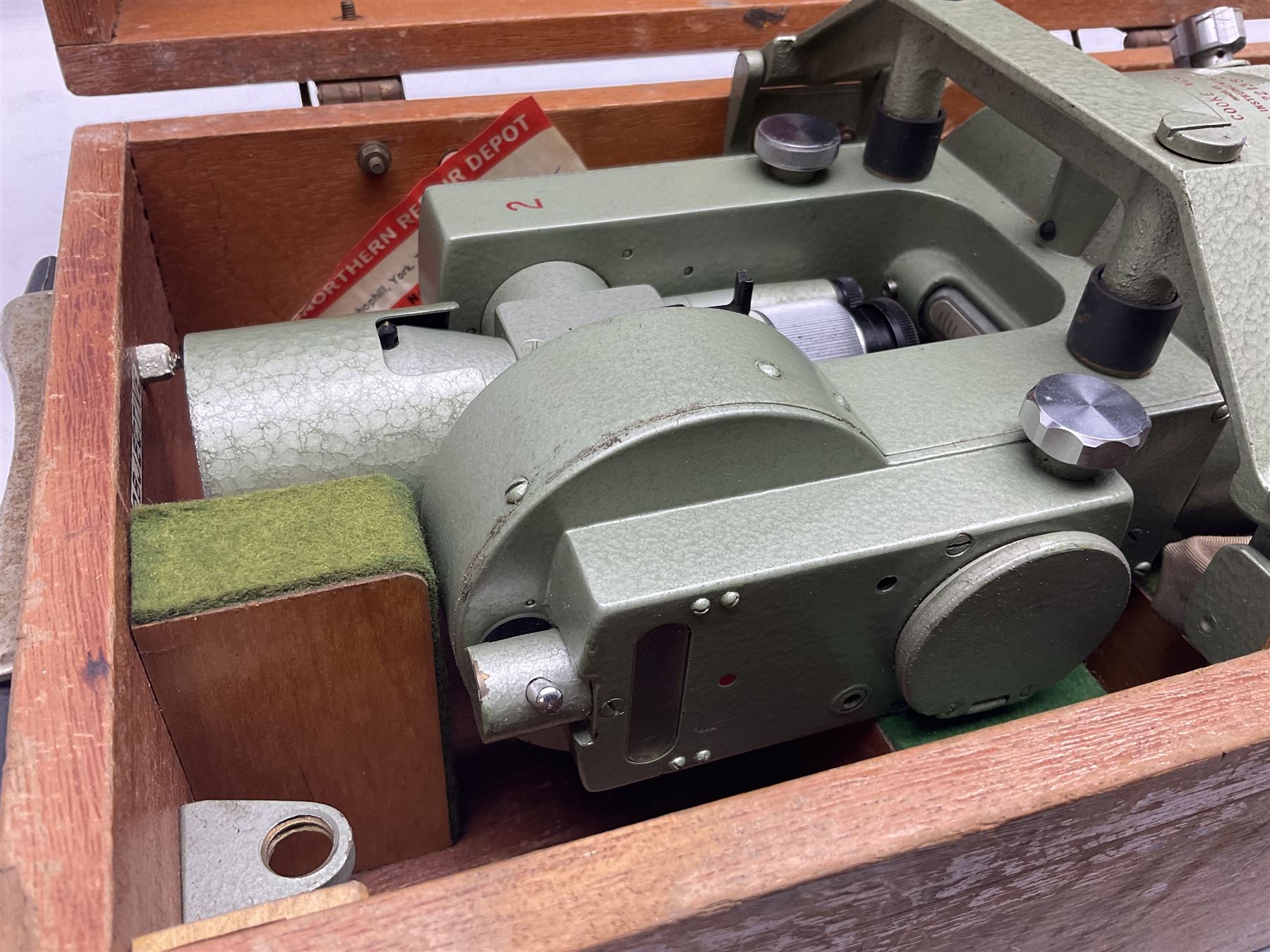 Vickers Instruments England Cooke V22 surveyor's theodolite, No.V.221387, with green enamelled body H32cm; in fitted wooden carrying box with retaining bar and repair label dated 3/8/77.