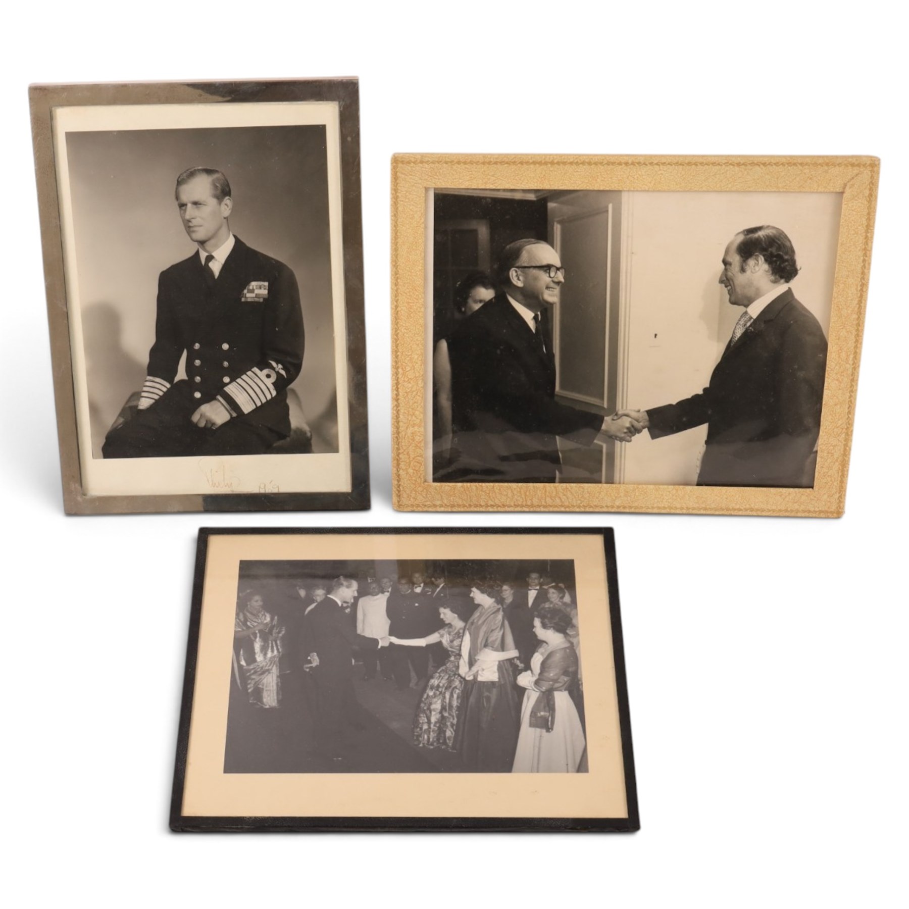 HRH The Duke of Edinburgh signed black and white presentation portrait photograph of Prince Philip wearing Naval uniform, signed in ink on mount ‘Philip 1959’, 20cm x 15cm, contained within a rectangular silver frame, together with a framed photograph of the Prince in India 1959 greeting guests at a formal event and a further black and white photograph