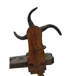 Early 19th century cobbler's work bench, in various woods, revolving cast iron last on yew wood supports, pine seat with inset maker's plaque inscribed 'No 7 Josh Blacker Harehills Leeds', on turned elm front supports and turned beech rear supports 