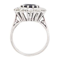 18ct white gold sapphire and diamond cluster ring, single oval cut sapphire of approx 4.50 carat, surrounded by twelve brilliant cut diamonds, Birmingham 1982, total diamond weight approx 2.65 carat