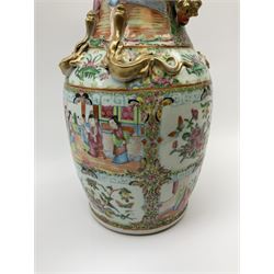 A 19th century Chinese Canton famille rose vase, of baluster form with waisted neck and lobed rim, the shoulder with four applied moulded dragons in gilt, and twin handles modelled as temple lions in gilt, the whole decorated with panels depicting figural courting scenes, and birds and butterflies amongst blossoming foliage, H35.5cm.