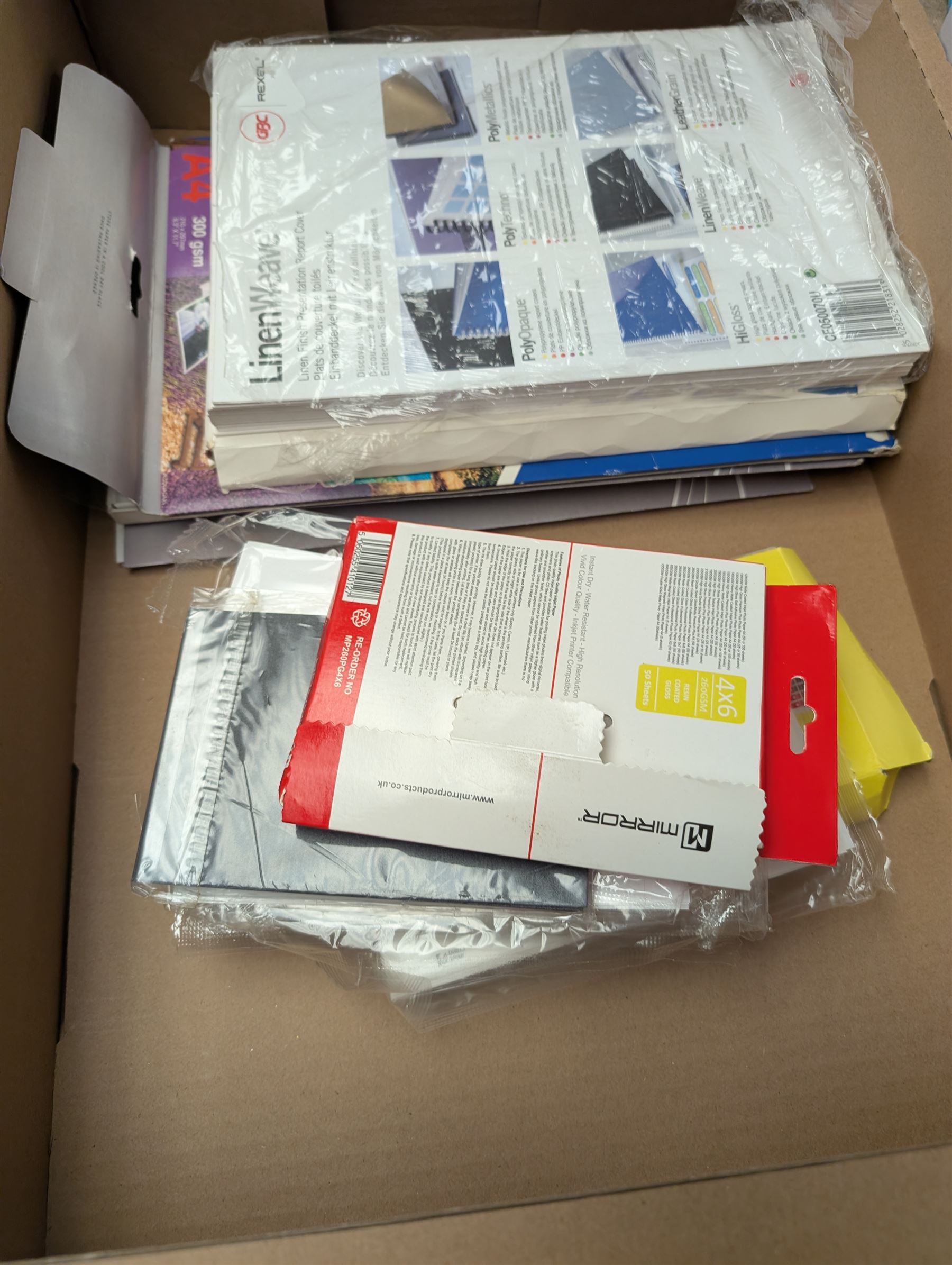 Epson ET-2750 ecotank printer, boxed with a collection of printing paper including photographic paper and postcards