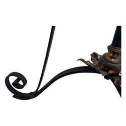 Late 19th century wrought iron and brass pulpit lamp, featuring an adjustable stem with a spiral twist detail, brass foliate mounts, and a tripod base with scrolled feet and decorative floral accents