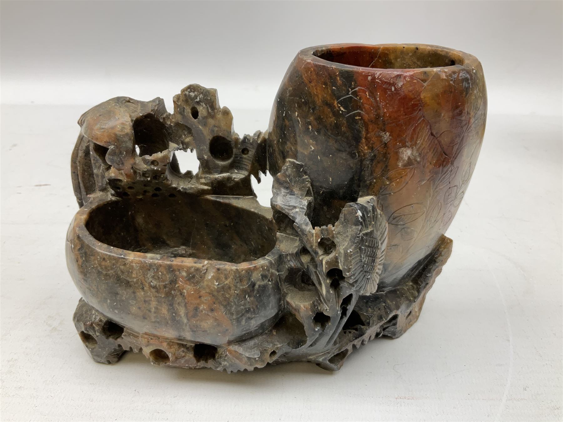 Three soapstone carvings, to include three toed dragon example, carved example with monkeys and another similar, together with carved wood figure, largest L29cm 