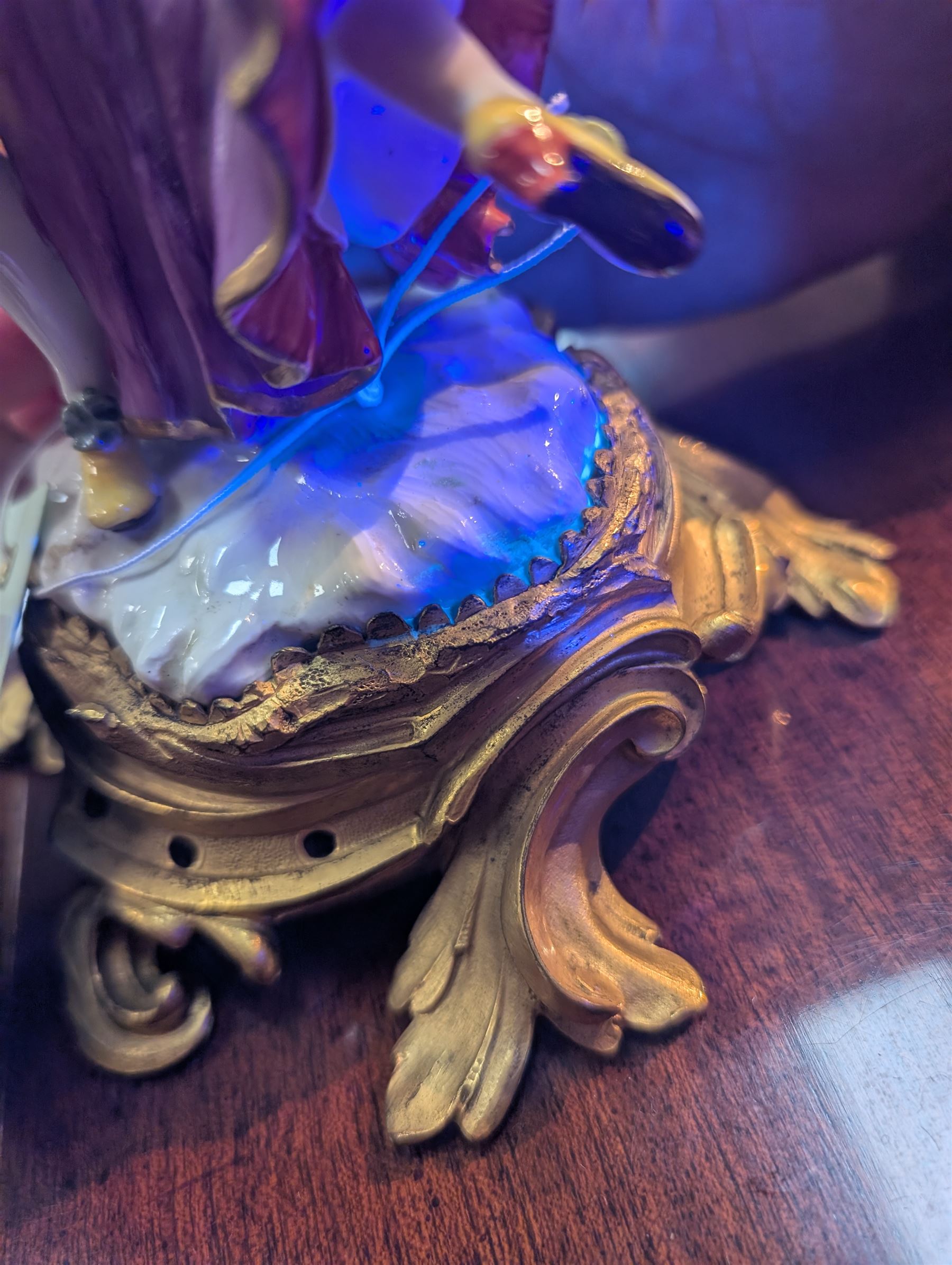 Mid 18th century Meissen figure group, The Tyrolean Dancers, circa 1740, modelled as two swirling figures with their arms linked, he in yellow hat with red rosette, blue jacket, red breeches with red rosette, and yellow shoes with green rosette, she in white blouse with red ribbons, yellow and red bodice, white apron over puce skirt and yellow shoes with green rosettes, her hair fashioned into two plaits secured by red ribbon, upon a shaped mound base, within a scrolling gilt metal mount, with blue crossed swords mark to base, overall H19cm
