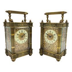French - Matching pair of Edwardian 8-day timepiece carriage clocks with bevelled rectangular glass panels and overlaid friezes in gilt repousse work with fretted dial masks,  circular enamel chapter ring with Arabic numerals and steel spade hands, both clocks with single train movements, one movement with a jewelled cylinder platform escapement and the other with a jewelled and silvered lever platform escapement.
No Keys.