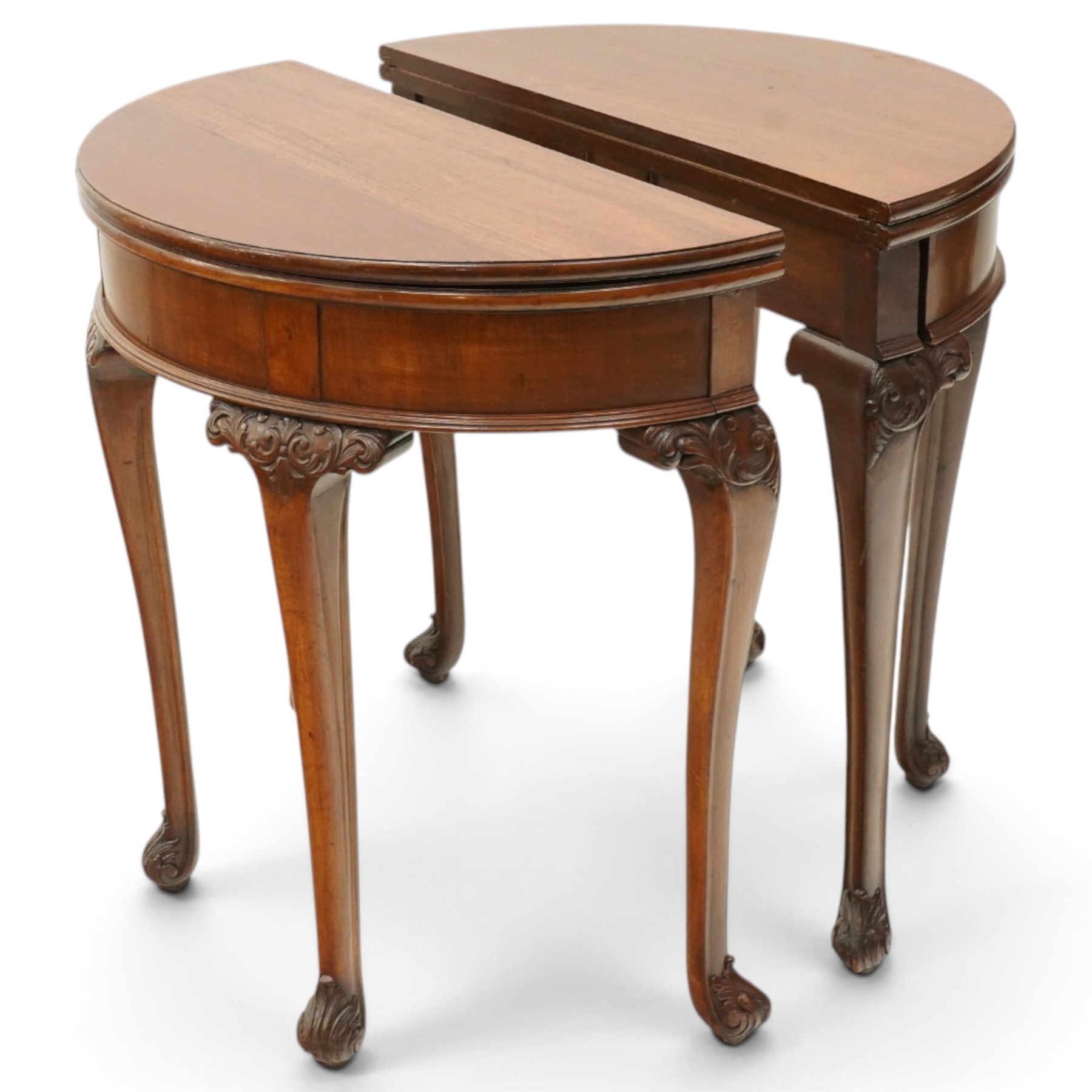Pair of Victorian mahogany demi-lune card tables, the lunette shaped fold-over top enclosing purple-baize lined interior and supported by gate-leg action, banded frieze over cabriole supports with scrolling acanthus leaf knees, terminating to scrolled foliate feet
