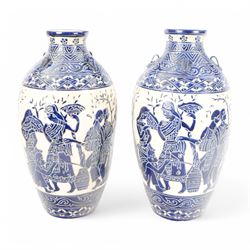 Pair of blue and white Grecian style urns, of baluster form with four small loop handles, ...