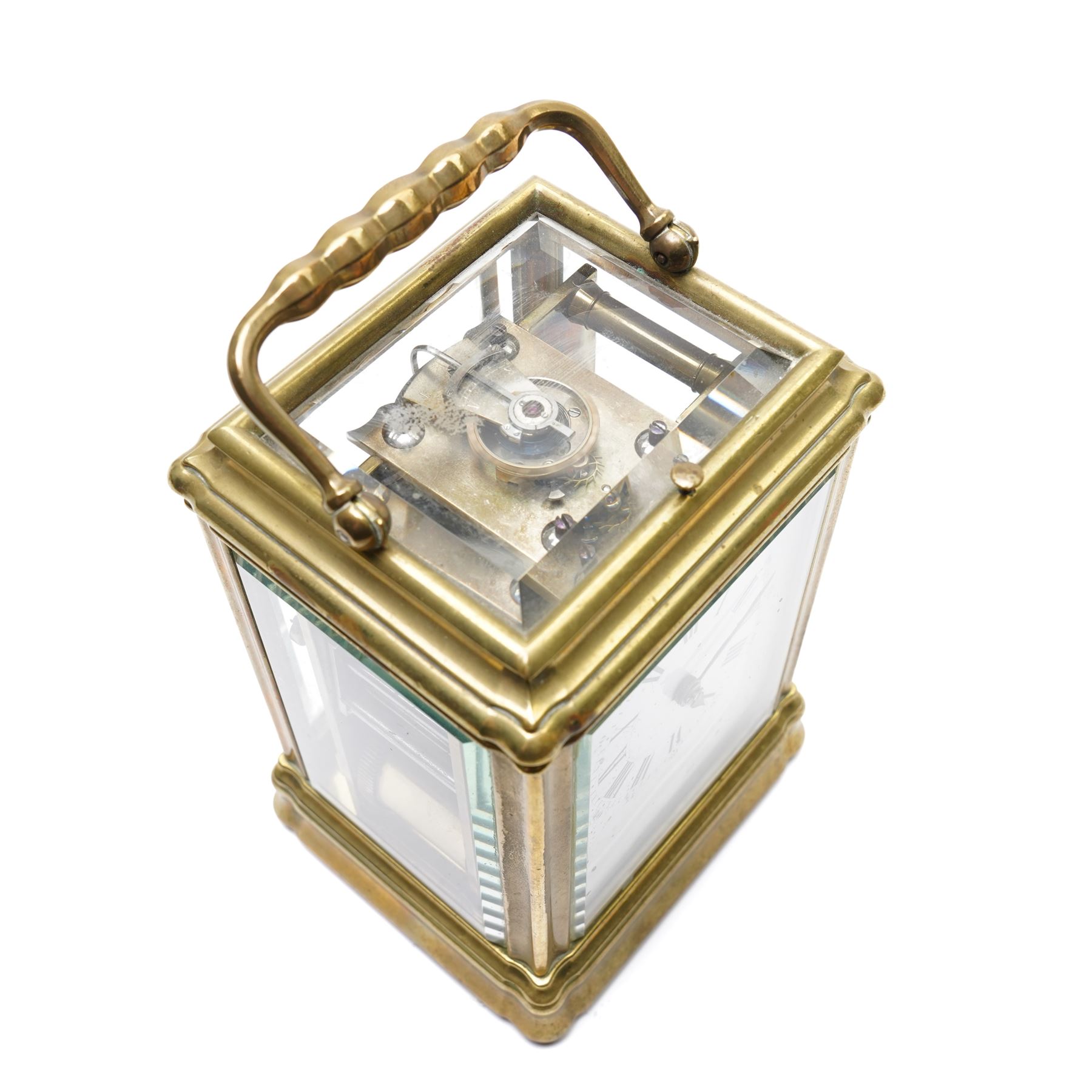 French-19th century 8-day quarter striking carriage clock with strike repeat in a Gorge case, white enamel dial with Roman numerals and steel spade hands, twin barrel movement striking the quarters and hours with two hammers on two coiled gongs to the backplate, silvered platform lever escapement with a jewelled balance and timing screws, with a full, strike, silent, and quarter selection lever to the base. 
Serial number 18874.