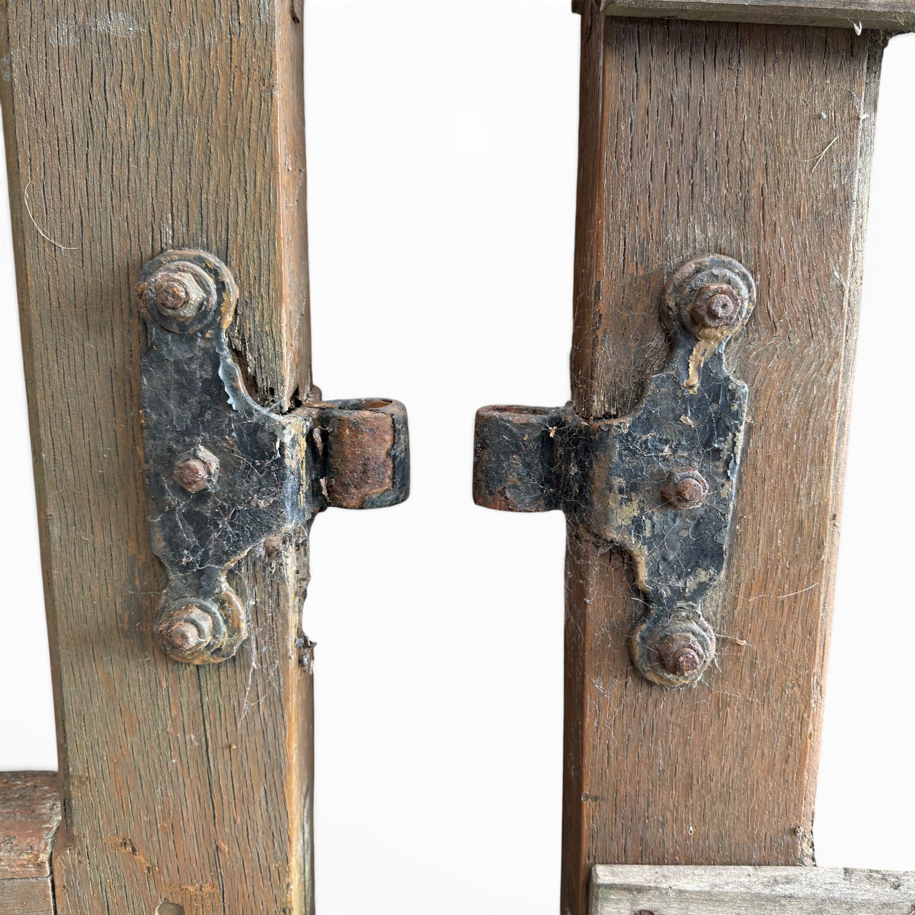 Pair of 19th century weathered wooden ecclesiastical church gates, the cresting rail over four pierced arches with slatted lower section, fitted with heavy cast iron hinges, latch and fittings