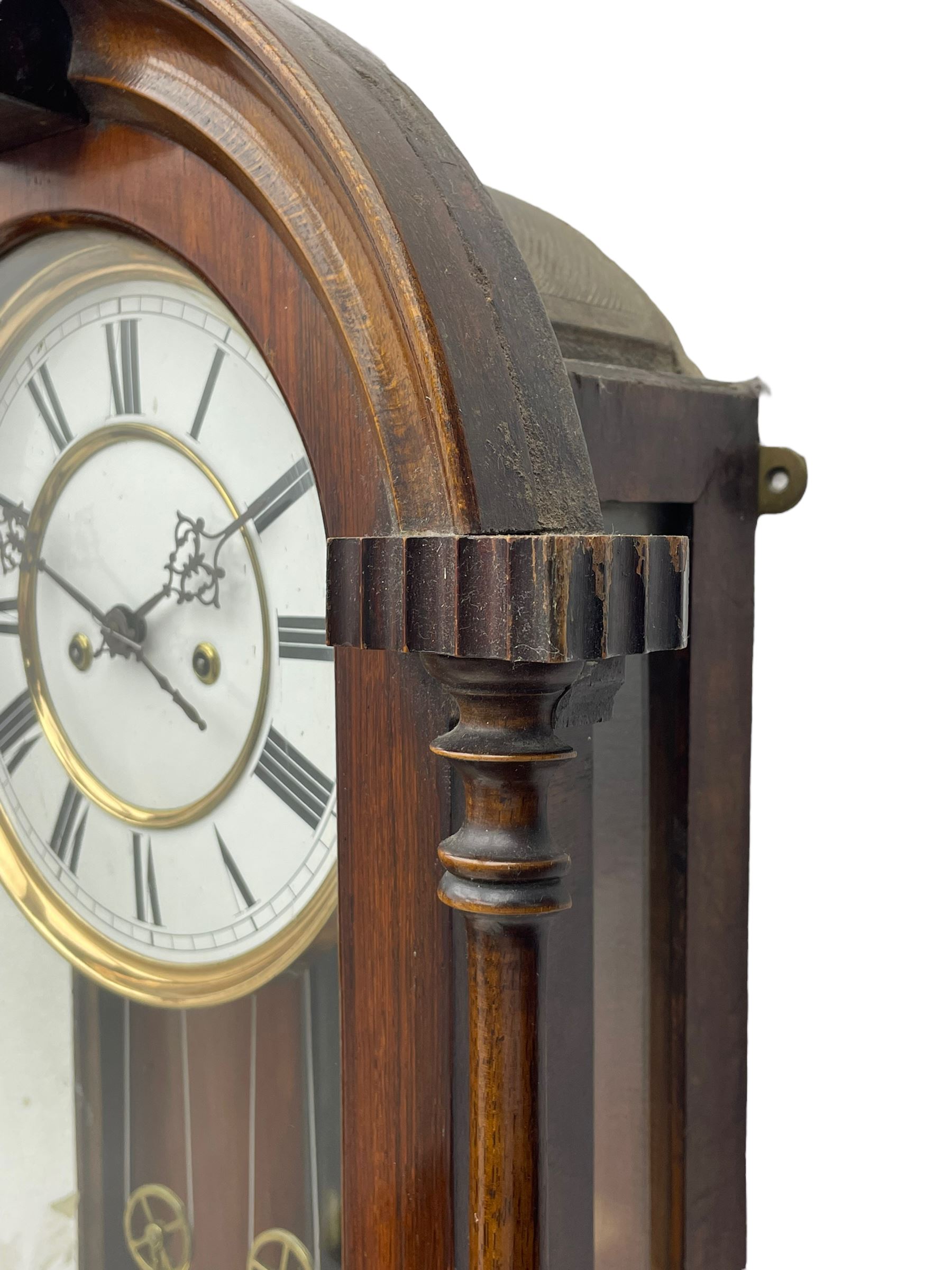 Lenzkirch – 8-day walnut cased weight driven Vienna regulator manufactured 1877-1878, with a break-arch pediment surmounted by a turned finial on a raised cavetto molding, fully glazed arched  door flanked by long ring turned pendants, flat base with open fretwork and two short pendants,  two piece enamel dial within a brass slip, Roman numerals, minute track and pierced steel hands, wooden pendulum with a brass faced bob, two brass cased weights and pulleys, dead beat escapement with a rack striking movement sounding the hours and half hours on a coiled gong, movement serial number 421410. 
Lenzkirch were one of Germanys most highly respected clock manufacturers of the 19th century, founded in the late 1850s the company produced movements and cases of high quality up until 1932.
