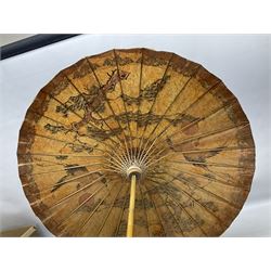Three carved oriental wood stands, with pierced decoration, and two oriental parasols