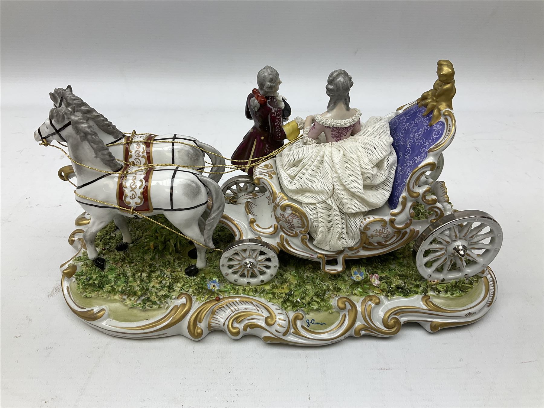 Capodimonte figure group of a horse drawn carriage with two horses pulling an open carriage with a male with dresden lace cuff and a female with full dresden lace skirt,  on a naturalistic base, H15.5cm