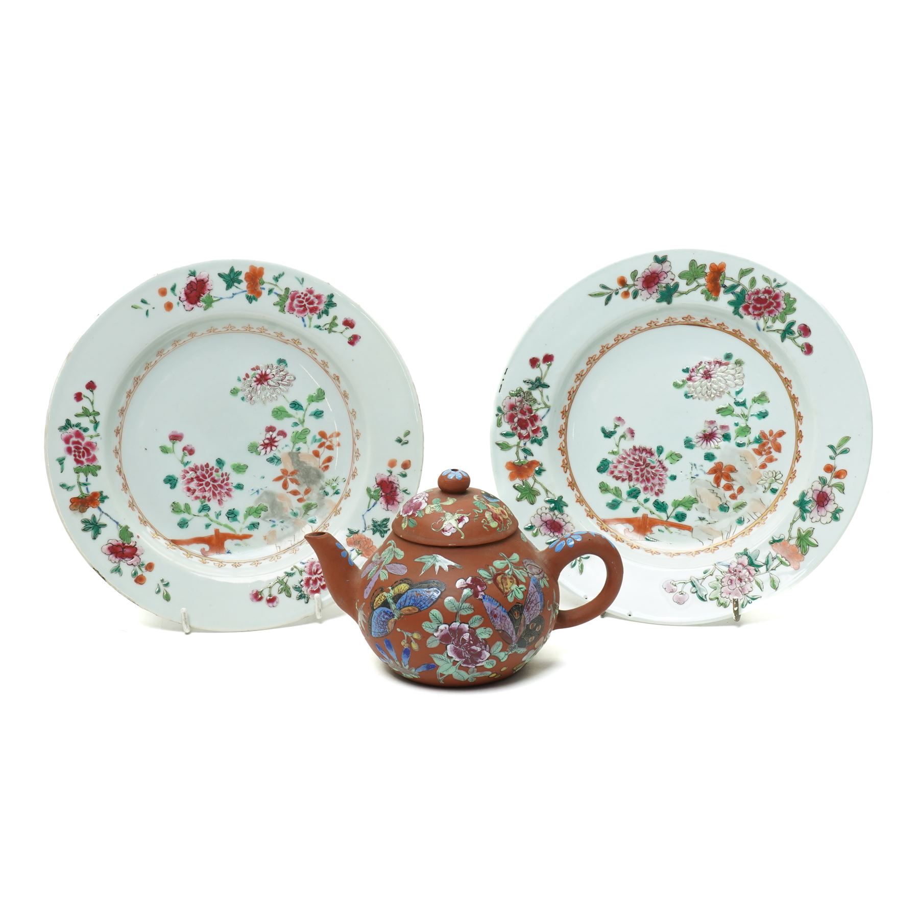 Pair of 18th century Chinese famille rose plates, painted profusely with flowers, D23cm; together with a Yixing teapot, painted with butterflies, H12cm (3)