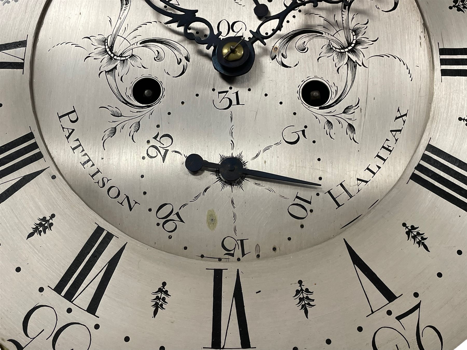 Pattison of Halifax - Late 18th century mahogany 8-day longcase clock, With a swans necked pediment and brass patera, recessed break arch hood door beneath flanked by plain turned pilasters with brass capitals, trunk with satinwood inlay, reeded columns and a curved top door with an ivory escutcheon, conforming plinth raised on bracket feet, brass dial with a rolling moon to the arch, cast spandrels , engraved and silvered dial centre  and chapter ring, chapter with Roman numerals, five minute Arabic's and minute markers, makers name to the dial centre with seconds and date work, dial pinned to a rack striking movement, striking the hours on a cast bell. With weights and pendulum. John Pattison is recorded as working in Halifax c1783.   

This item has been registered for sale under Section 10 of the APHA Ivory Act