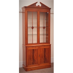  Charles Barr quality reproduction mahogany bookcase display cabinet on cupboard, swan neck pediment, glazed doors enclosing shelves above slide and two cupboard doors on plinth base, W101cm, H233cm, D41cm  