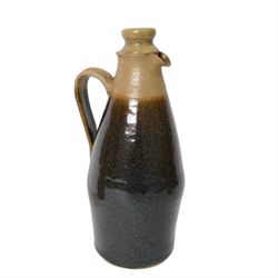 British, a stoneware jug and cover in the manner of Richard Batterham, together with two  stoneware gin flagons 