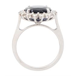 18ct white gold sapphire and diamond cluster ring, single oval cut sapphire of approx 4.30 carat, sounded by eighteen round brilliant cut diamonds, stamped, total diamond weight approx 0.75 carat
