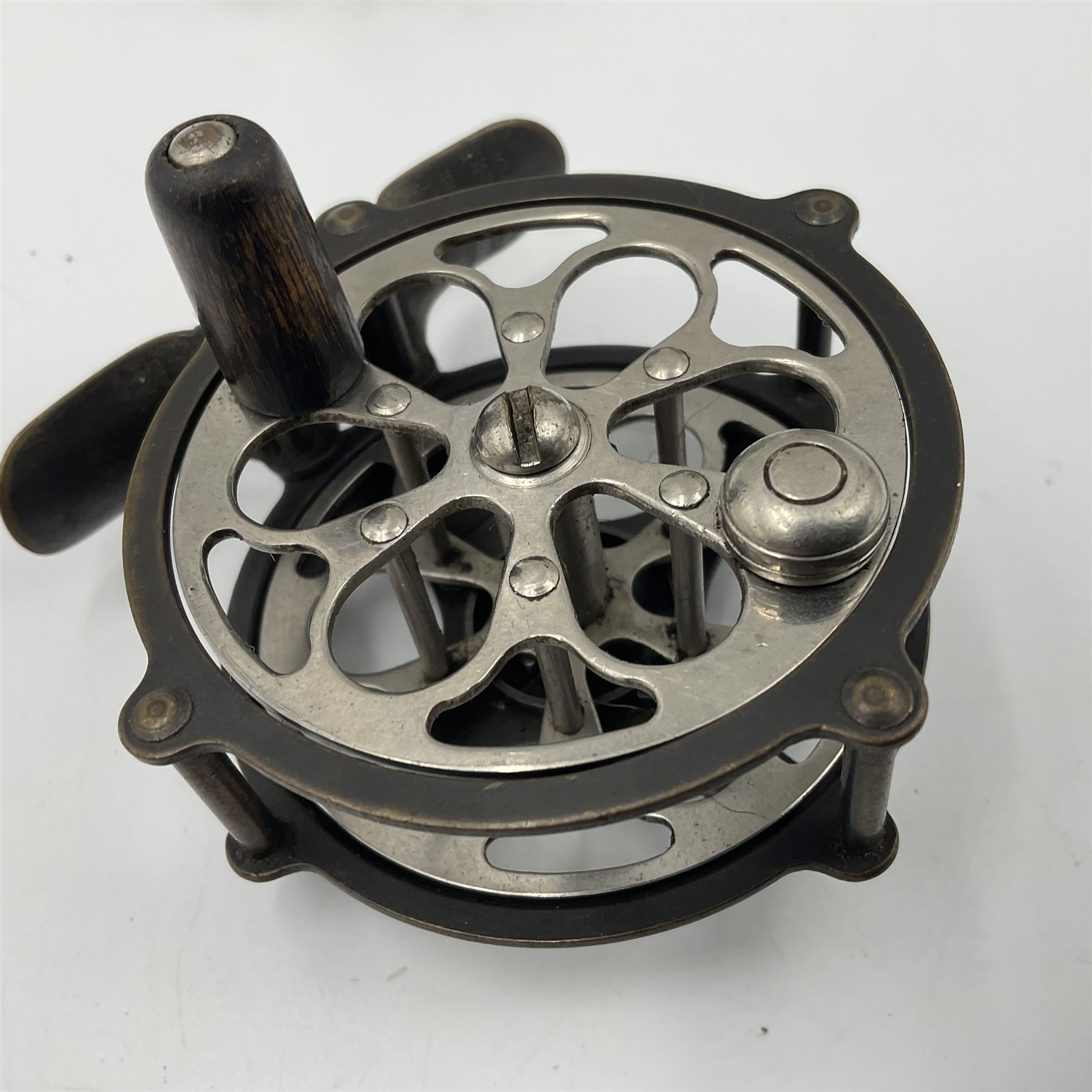 TO RTV Three fishing reels, including American Pflueger progress bulldog size 60 brass and chrome skeleton fly reel, with wooden handle; Maginot 106 fly reel and an alloy reel (3)