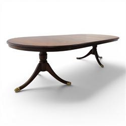 Regency design mahogany extending twin pedestal dining table with two additional leaves, raised on splayed supports terminating brass paw feet
Extends to 268cm