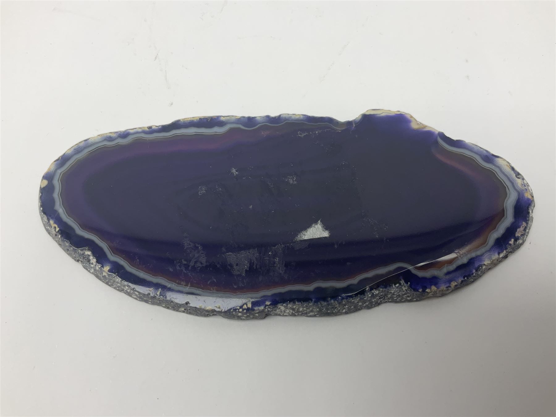 Four purple agate slices of various sizes, polished with rough edges