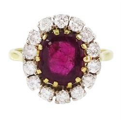 18ct gold garnet and diamond cluster ring, single cabochon cut garnet surrounded by twelve brilliant cut diamonds, London 1970, total diamond weight approx 0.60 carat 