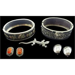 Early 20th century silver rose design hinged bangle, one other engraved leaf design bangle, silver marcasite lizard brooch, silver carnelian and marcasite clip on earrings and one other pair of silver earrings, all stamped or tested 