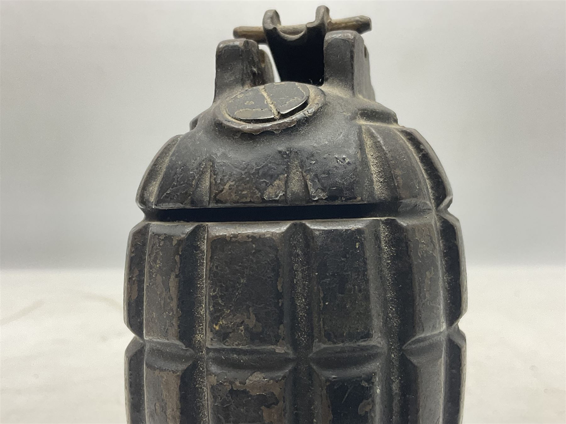 Two inert WW2 Mills Bomb (pineapple) hand grenades; one adapted as a money box with coin slit to the side and later cap H9.5cm (2)